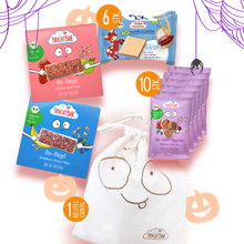 Halloween Set mit Snacks und Snackbeutel neben lila Spinnenweben und Kürbissen